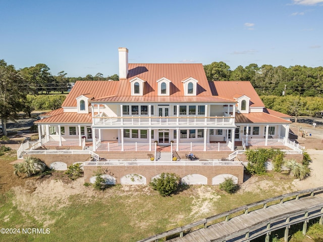 back of house with a pool, a balcony, and a patio