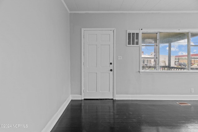 interior space featuring ornamental molding and dark wood-type flooring