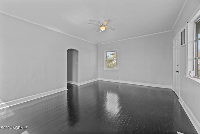 empty room featuring ornamental molding and dark wood-type flooring