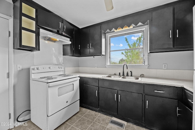 kitchen featuring light tile floors, wall chimney range hood, ceiling fan, electric range, and sink