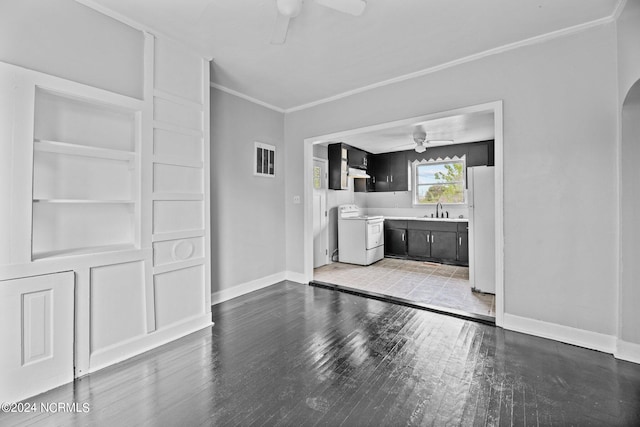 spare room with sink, ceiling fan, and hardwood / wood-style flooring