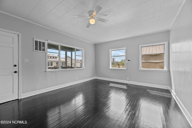 spare room with ceiling fan, ornamental molding, and dark wood-type flooring