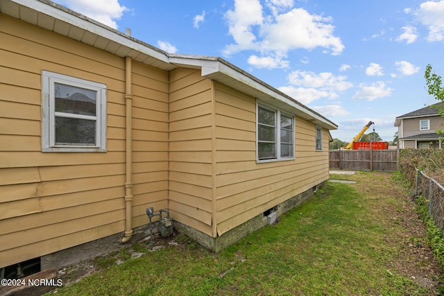 view of side of home featuring a lawn