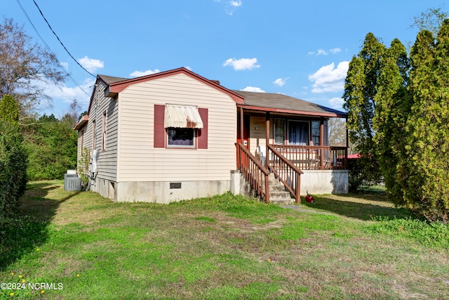 view of front facade with central AC unit and a front yard