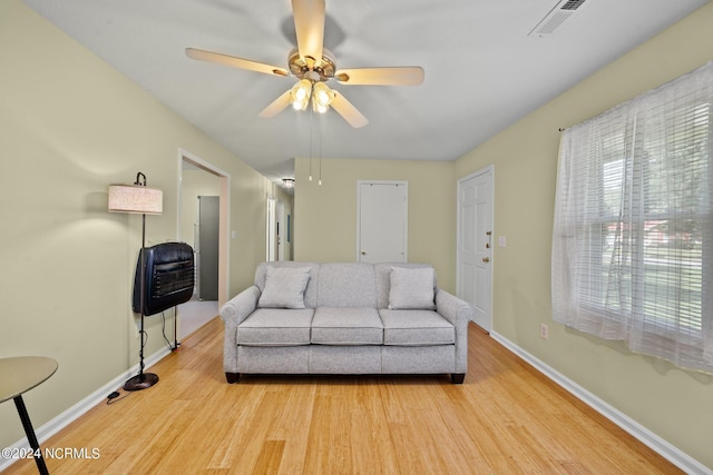 living room with light hardwood / wood-style flooring and ceiling fan