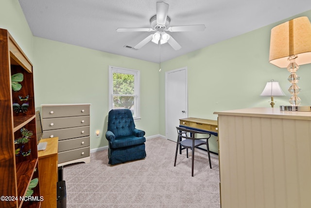 carpeted home office featuring ceiling fan