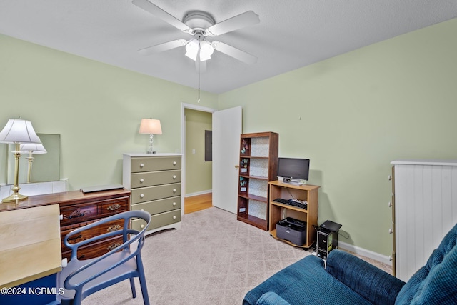 carpeted office space featuring ceiling fan