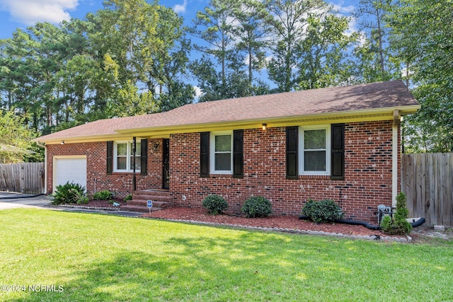 single story home featuring a garage and a front lawn