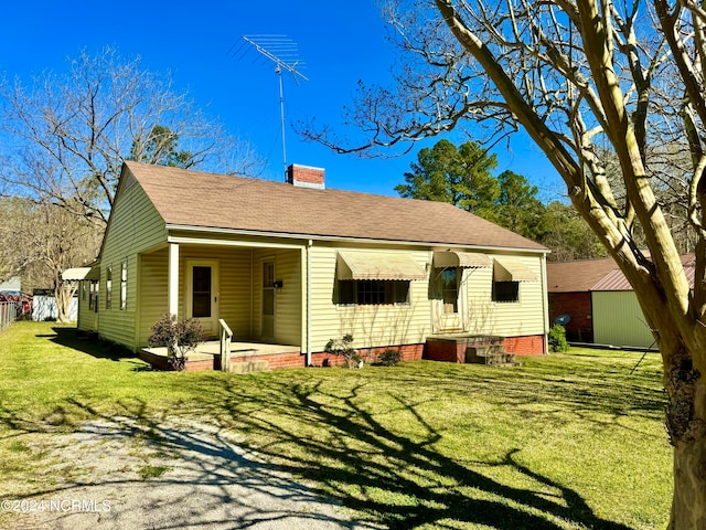 rear view of house with a yard