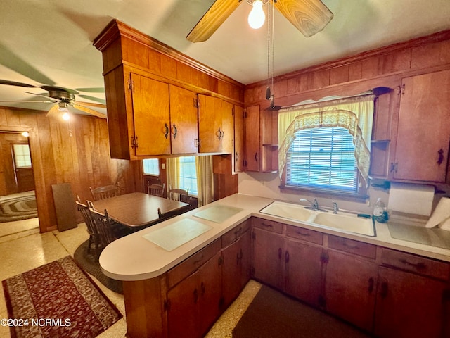 kitchen with ceiling fan, sink, and kitchen peninsula