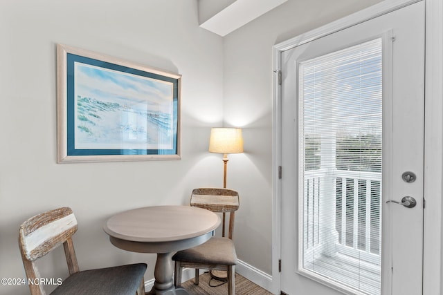 sitting room with a wealth of natural light and hardwood / wood-style flooring