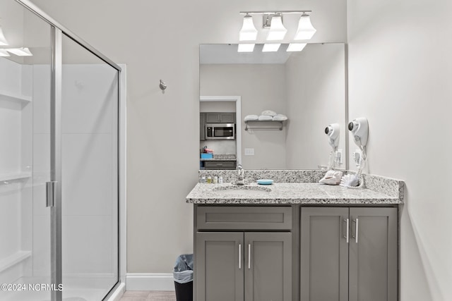 bathroom featuring oversized vanity, tile flooring, and walk in shower