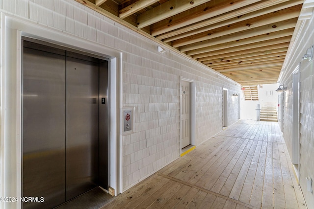 exterior space featuring light hardwood / wood-style floors and elevator