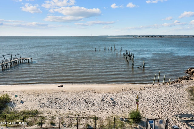 dock area with a water view and a view of the beach