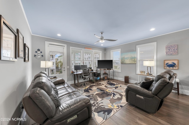 living room with crown molding, dark hardwood / wood-style floors, and ceiling fan