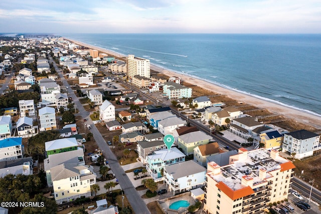 drone / aerial view featuring a water view and a view of the beach