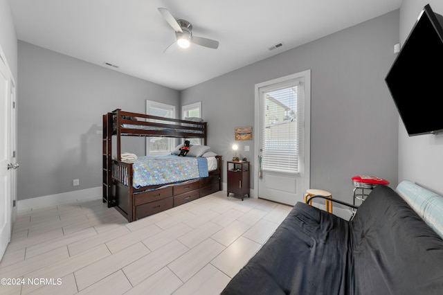 bedroom with ceiling fan and light tile floors