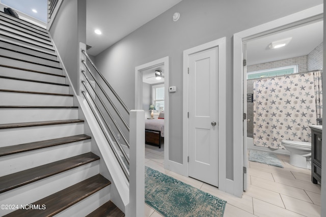 stairs featuring light tile floors and a wealth of natural light