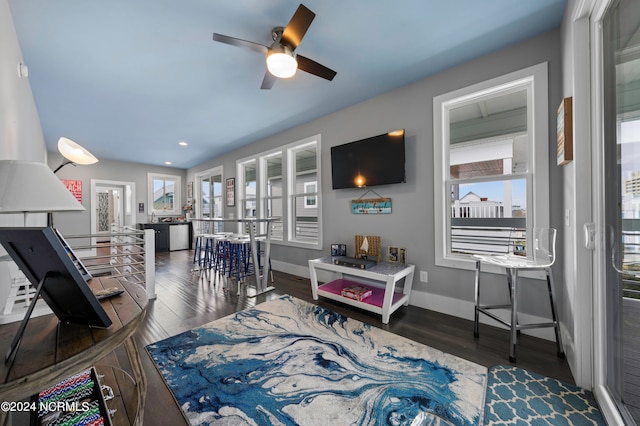 living room with ceiling fan and dark hardwood / wood-style floors