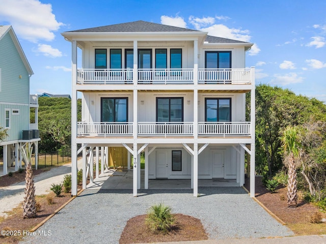 coastal home featuring a carport and a balcony