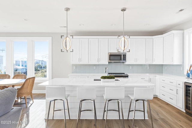 kitchen with pendant lighting, a kitchen island, and appliances with stainless steel finishes