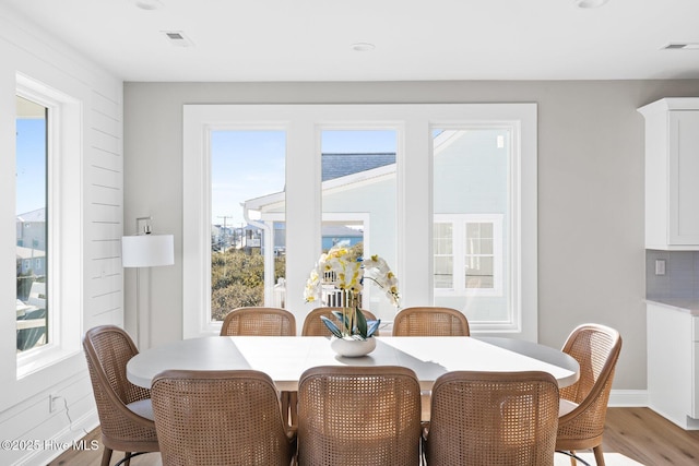 dining room with a wealth of natural light and light hardwood / wood-style floors