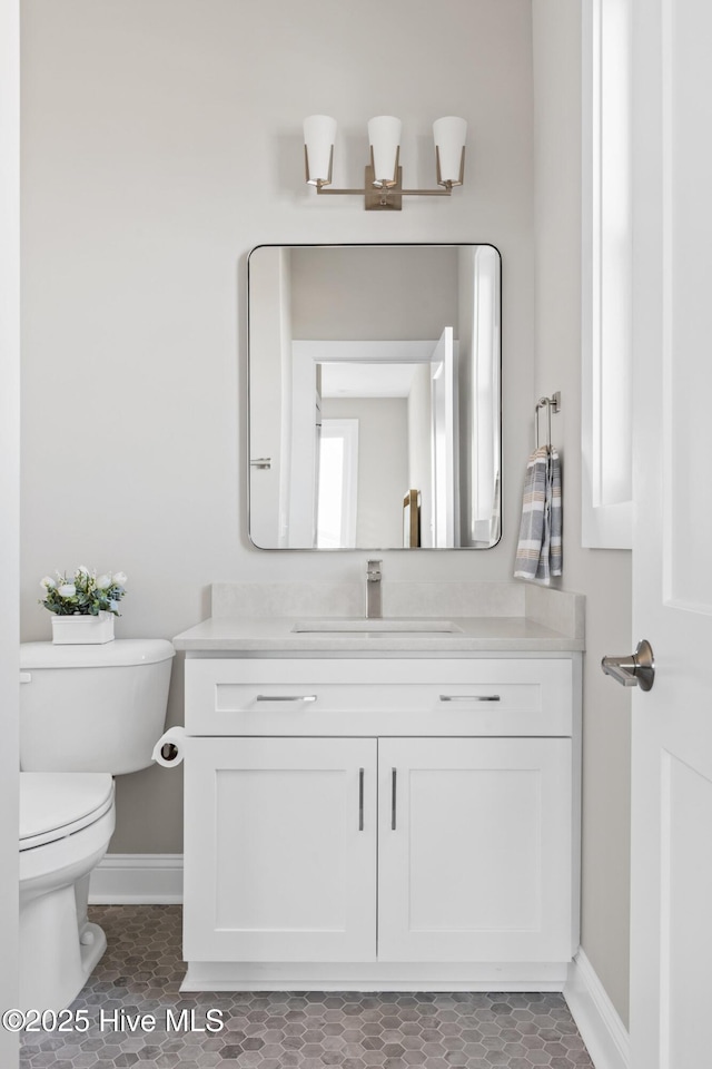 bathroom featuring vanity and toilet