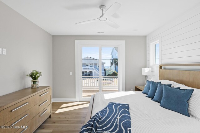 bedroom featuring dark hardwood / wood-style flooring, access to outside, and ceiling fan