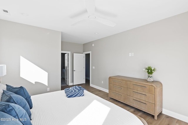 bedroom with ceiling fan and dark hardwood / wood-style flooring