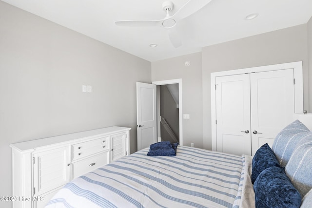 bedroom with ceiling fan and a closet