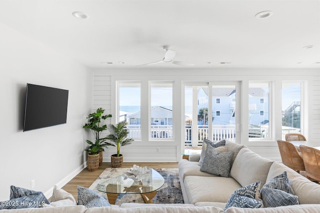 living room featuring hardwood / wood-style floors and ceiling fan