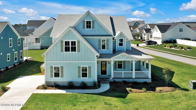 view of front facade with a front yard and a porch