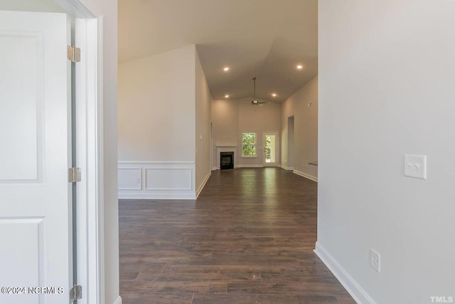 hallway featuring dark wood-style flooring, vaulted ceiling, recessed lighting, and wainscoting