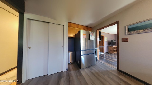 kitchen featuring stainless steel refrigerator and dark hardwood / wood-style floors