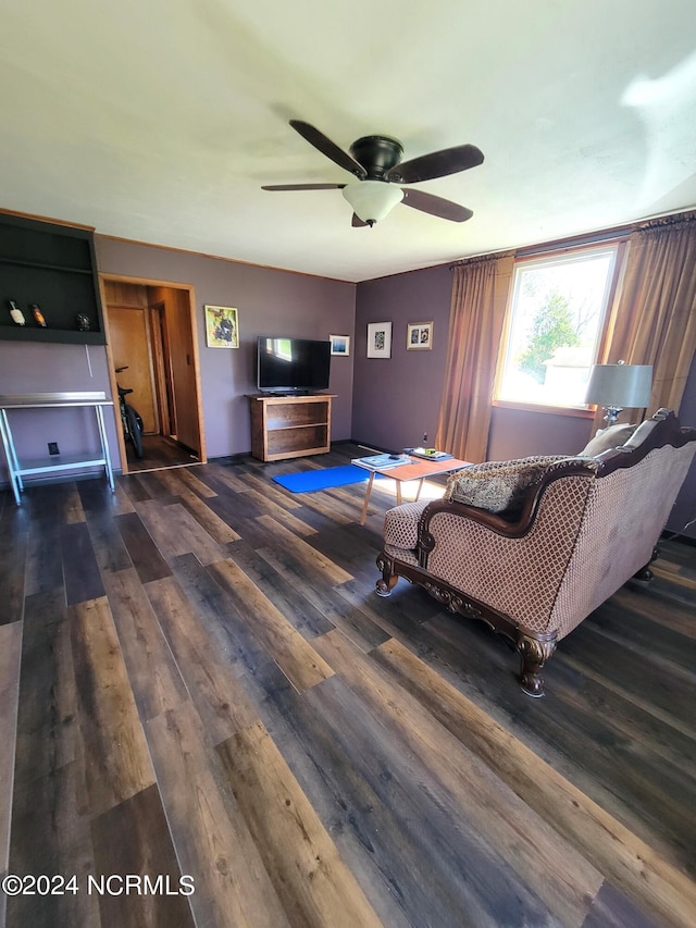 unfurnished living room featuring dark hardwood / wood-style flooring and ceiling fan