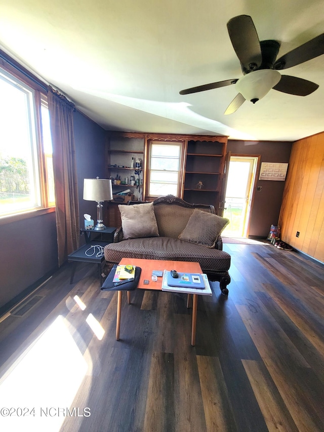 living room with a healthy amount of sunlight, ceiling fan, and dark hardwood / wood-style floors