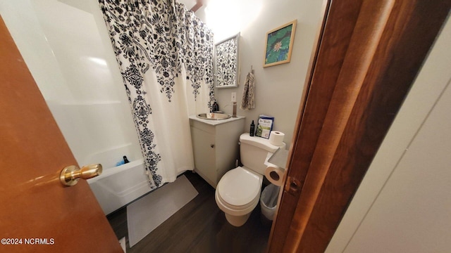 full bathroom featuring toilet, shower / tub combo with curtain, hardwood / wood-style floors, and vanity