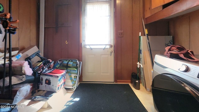 laundry room featuring washer / dryer and wood walls