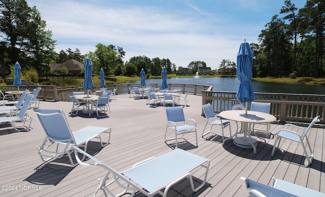 wooden terrace featuring a water view