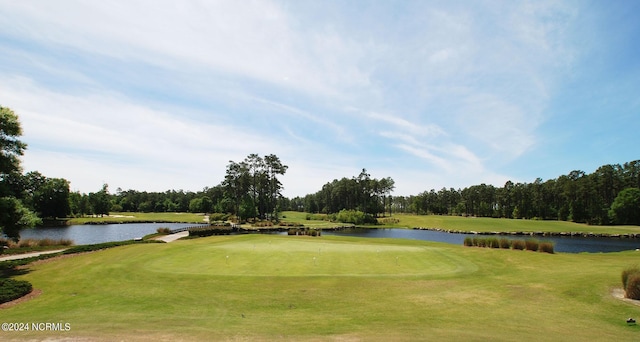 view of community with a lawn and a water view