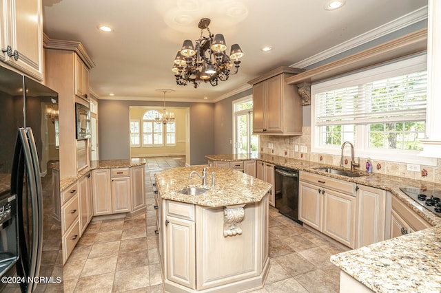 kitchen with black appliances, a kitchen island with sink, sink, and a chandelier