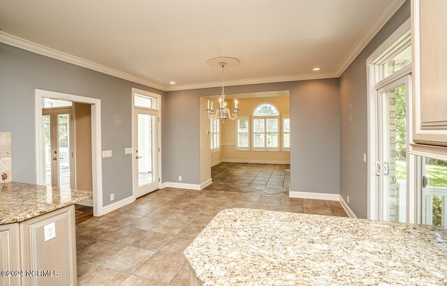 interior space featuring a healthy amount of sunlight, crown molding, and a notable chandelier