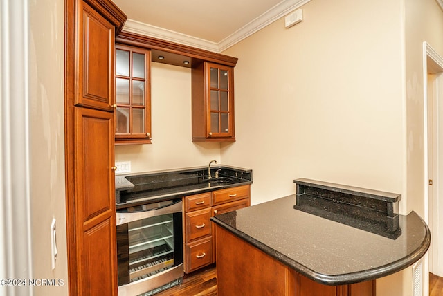 kitchen with beverage cooler, crown molding, dark hardwood / wood-style flooring, and sink