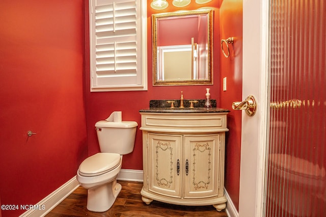 bathroom with vanity, hardwood / wood-style floors, and toilet