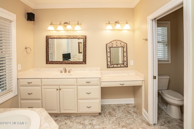 bathroom featuring ornamental molding, a tub, vanity, and toilet