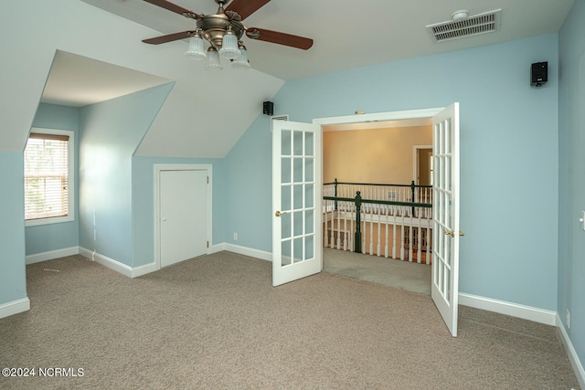 bonus room featuring lofted ceiling, ceiling fan, and light colored carpet