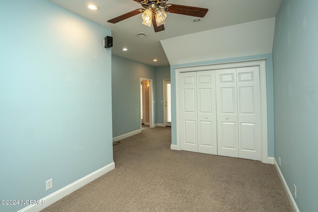 unfurnished bedroom featuring carpet floors, a closet, and ceiling fan