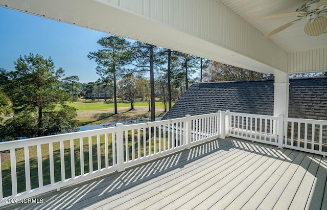 deck with a lawn and ceiling fan