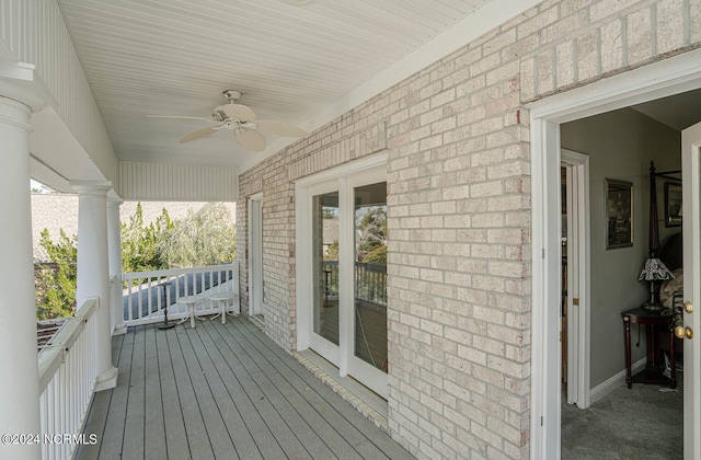 wooden terrace featuring ceiling fan