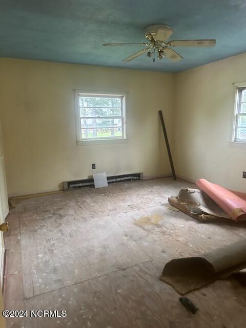 empty room with plenty of natural light and ceiling fan